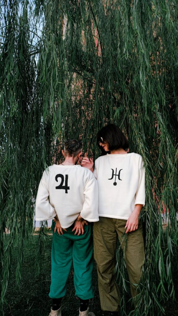 pexels-photo-19232486 Models in Loose Fleece Printed Sweatshirts Under Willow Branches